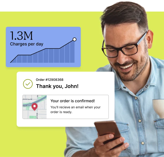 A person smiling while looking at a smartphone showing an order confirmation for an ecommerce purchase.