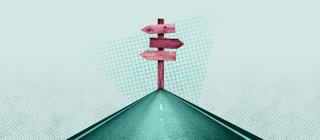 A green road leads to a pink sign with arrows pointing in different directions.