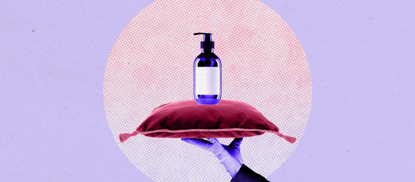 A hand holding a pillow with a bottle of skincare.