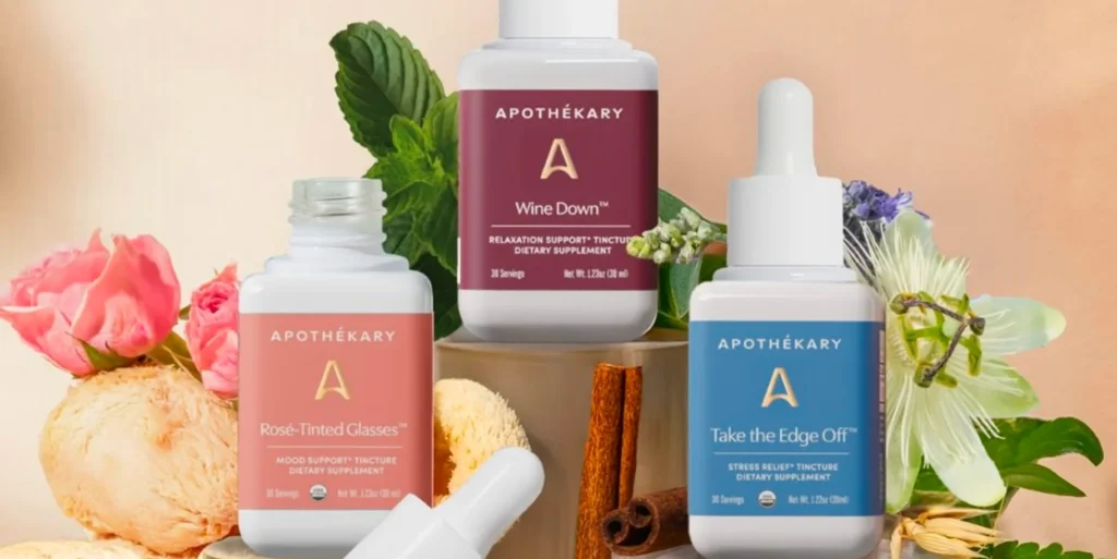 A collection of three tinctures by Apothékary surrounded by flowers and natural elements.