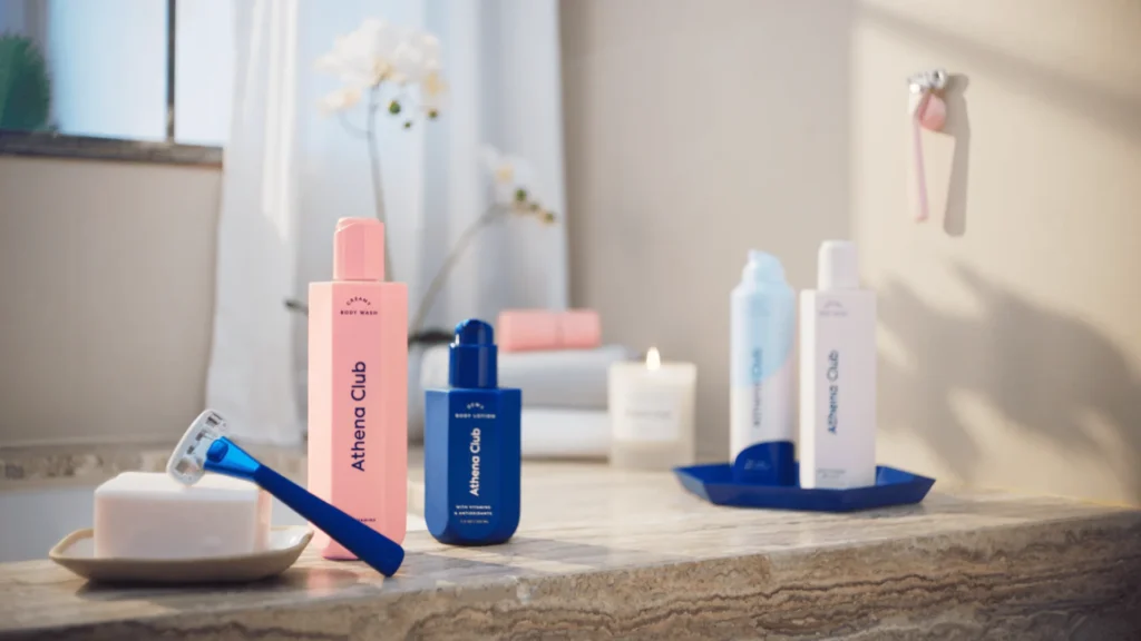 Various Athena Club body wash products displayed on a bathroom countertop.