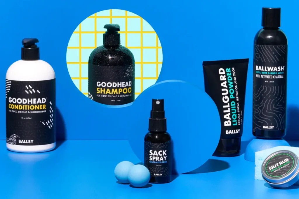 A collection of grooming products including GOODHEAD Conditioner, BALLWASH, and a Sack Spray arranged on a blue background.