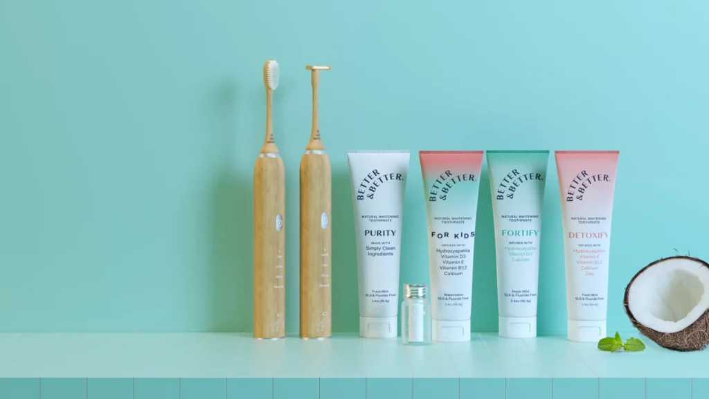 Two Better & Better toothbrushes and four toothpaste tubes displayed against a blue background.