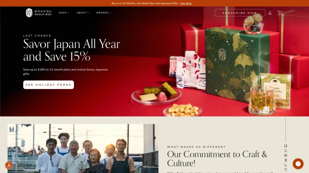 A beautifully arranged holiday gift box with Japanese snacks and a plate of traditional treats.