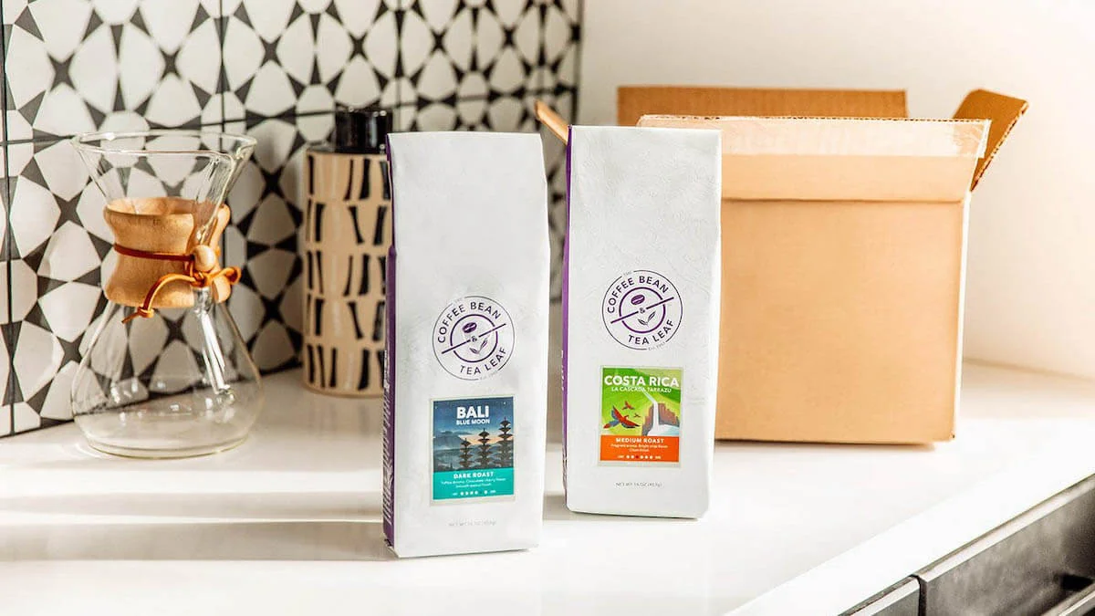 Two bags of coffee beans from Coffee Bean & Tea Leaf displayed on a countertop.