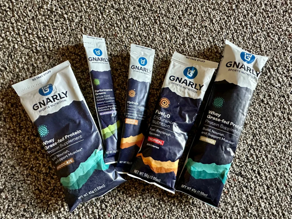 Various Gnarly Sports Nutrition products displayed on a textured surface.