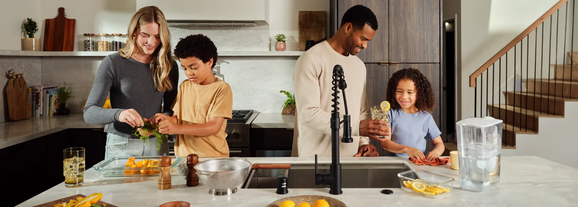A family cooking together in a modern kitchen.