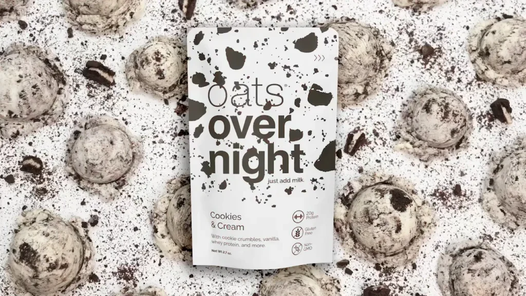 Oats overnight cookies and cream packaging surrounded by crushed cookies.