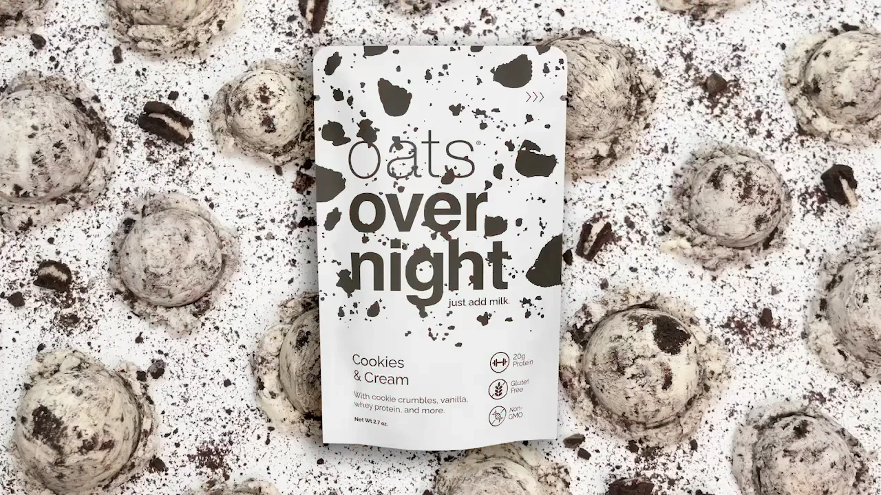 Oats overnight cookies and cream packaging surrounded by crushed cookies.