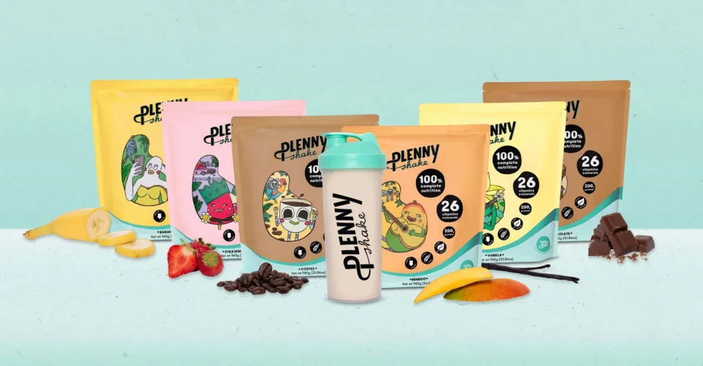 Multiple flavors of Plenny Shake packaging arranged with fruits and ingredients.