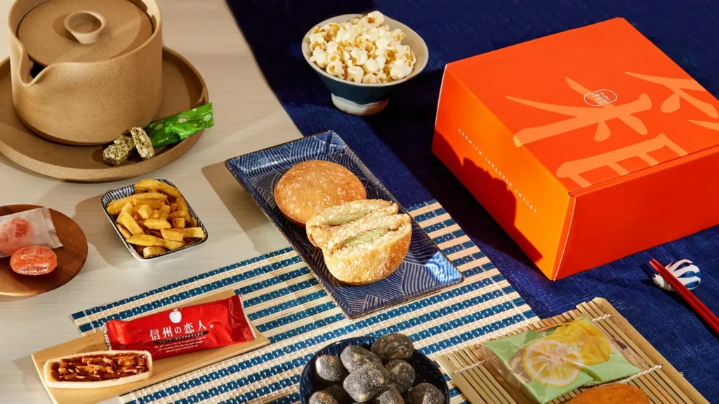 A diverse Japanese snack spread including pastries and popcorn.