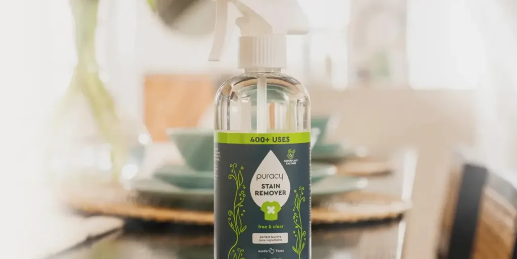 A close-up of a bottle of puracy stain remover on a table.