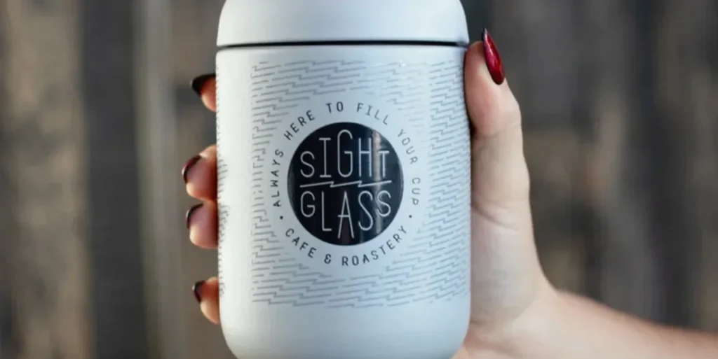 A person holding a white container from Sight Glass.