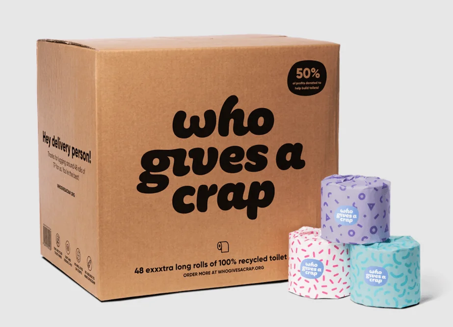 A box containing rolls of recycled toilet paper with a delivery note displayed on top.