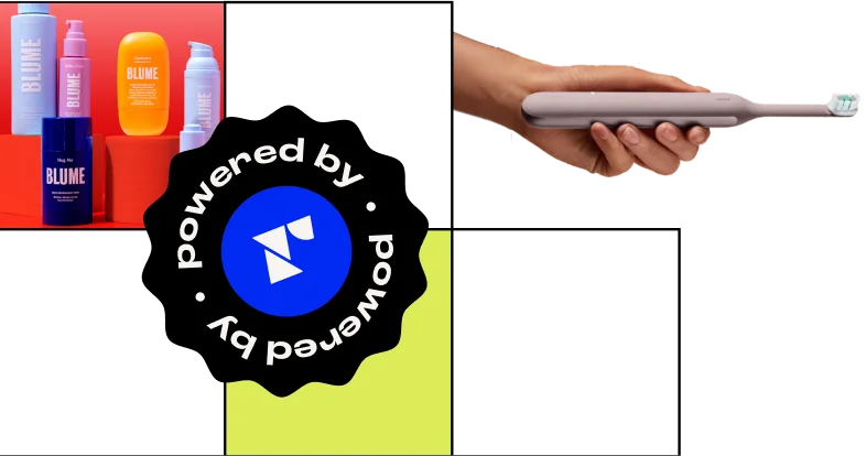 A person holding a gray electric toothbrush with colorful Blume products in the background.