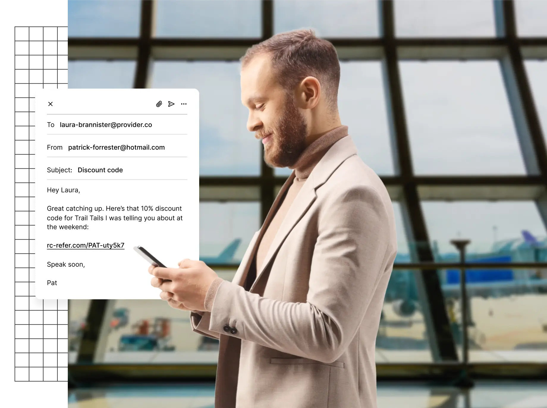 A person in a suit holding a smartphone, with an email on the screen.