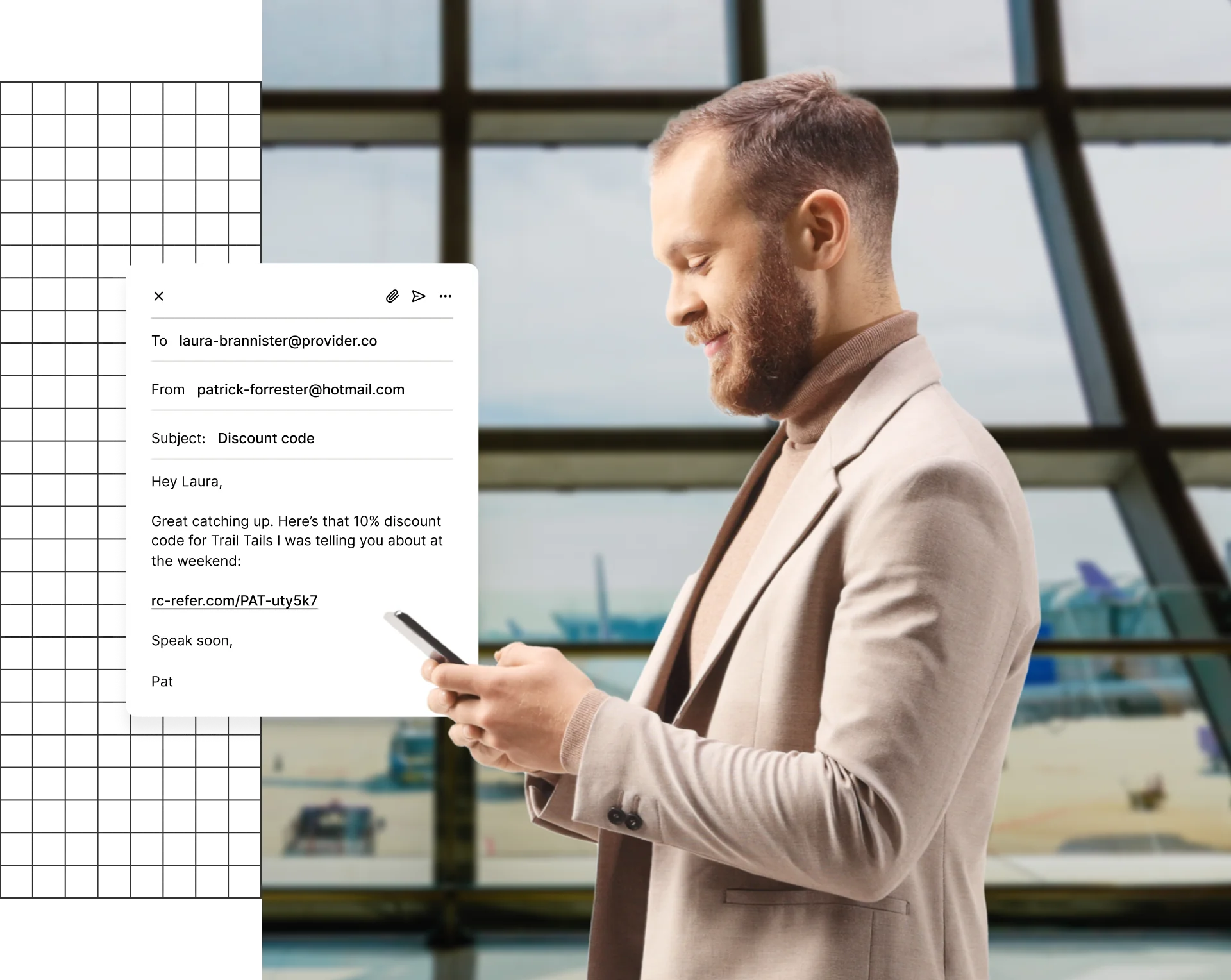 A person in a suit holding a smartphone, with an email on the screen.