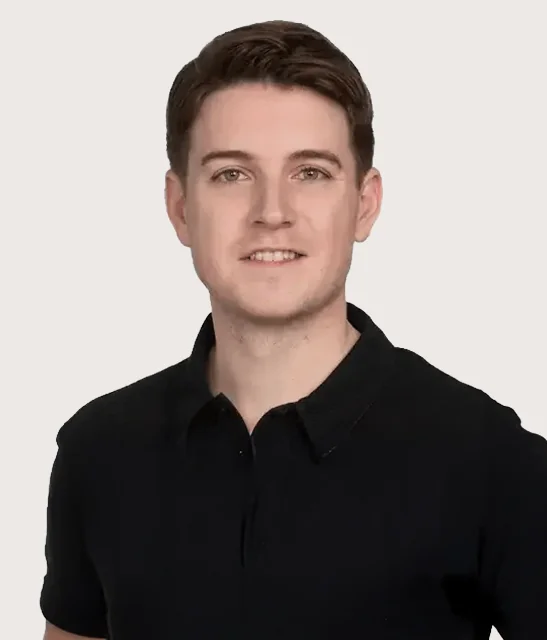 A person smiling and wearing a black polo shirt.