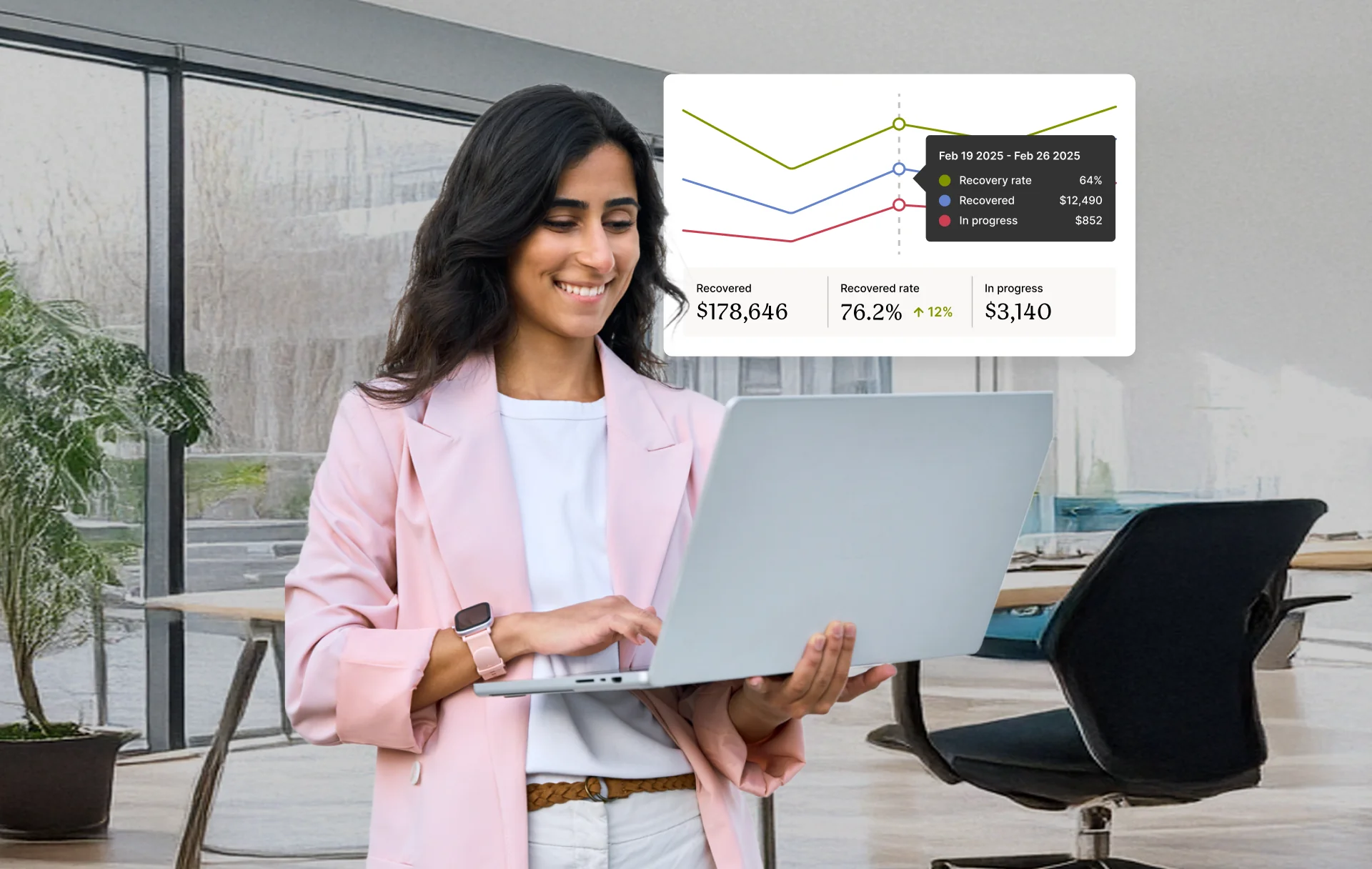 A woman looking at recovery analytics on a laptop inside a modern office environment.