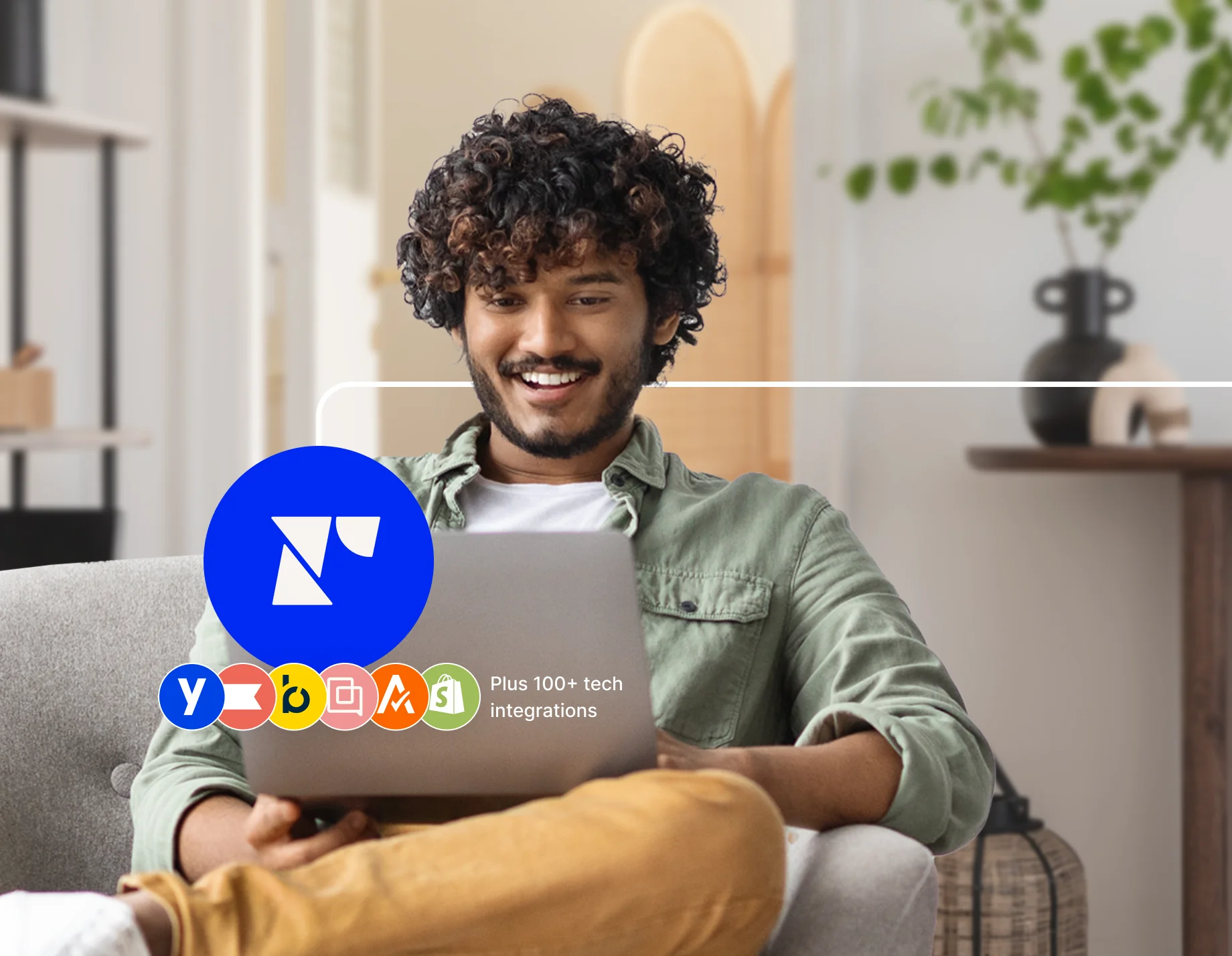 A man engaged with a laptop showing tech integrations related to Recharge.