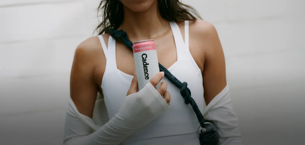 A person holding a can of watermelon mojito drink labeled Cadence.